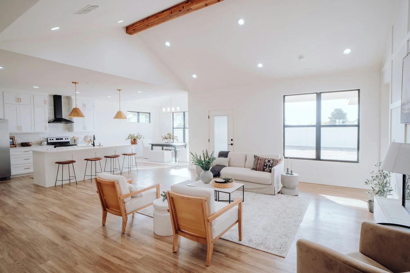 A bright, open living room and kitchen with natural light